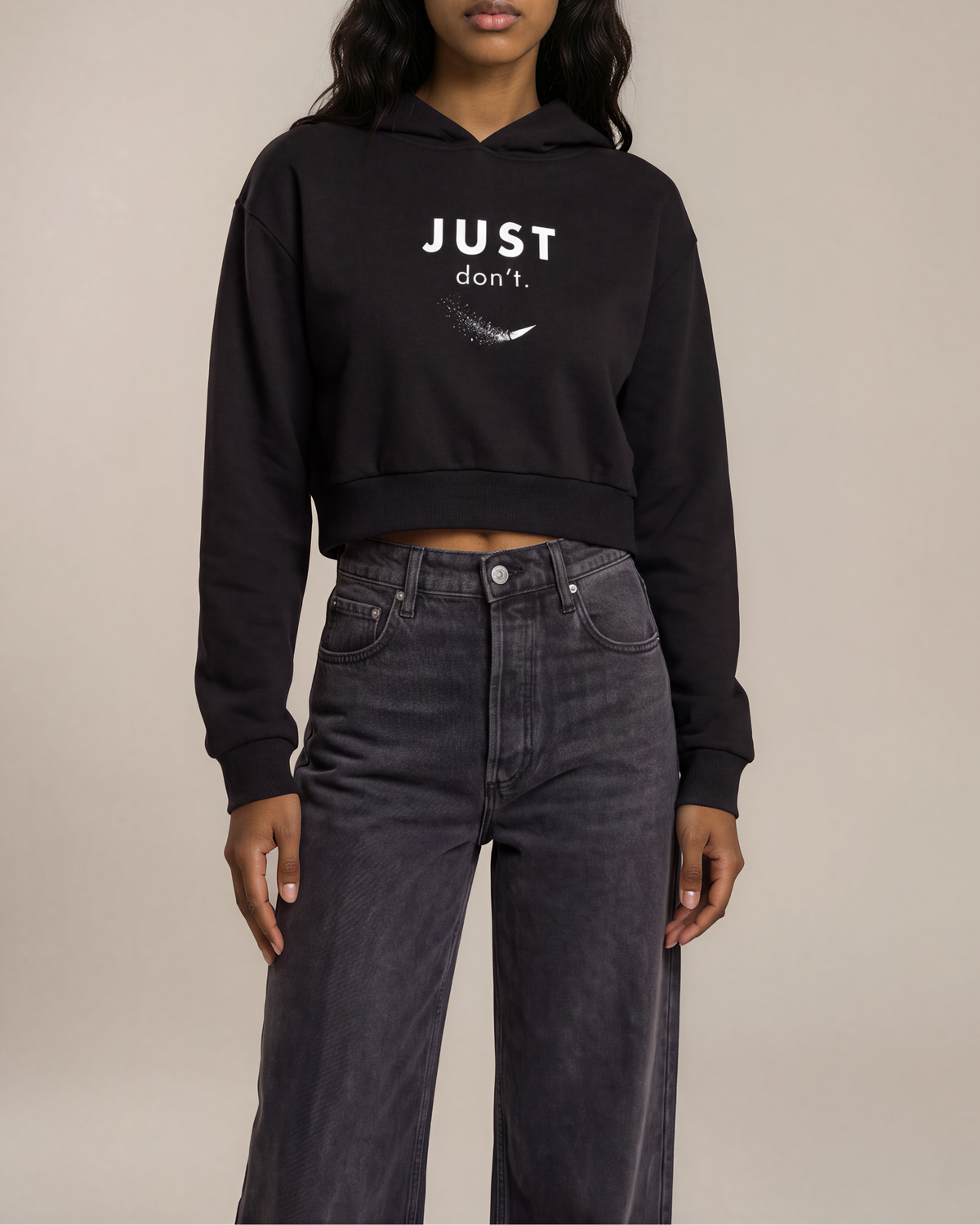 Model wearing the black Just Don’t Women’s Cropped Hoodie, front view